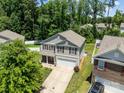 Aerial view of a well-maintained two-story home with a lush green yard, complemented by mature trees and a private backyard at 5009 Granite Creek Ln, Charlotte, NC 28269