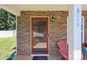 Inviting front porch with a stylish stone facade, leading to a cozy entrance and a pop of color from outdoor seating at 5009 Granite Creek Ln, Charlotte, NC 28269