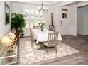 Bright dining room featuring a window with shutters, modern light fixture, and neutral decor at 5332 Pembrey Dr, Denver, NC 28037