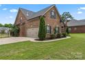 View of the house, showcasing the attached garage and well-maintained backyard at 5379 Roberta Meadows Ct, Concord, NC 28027