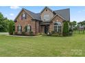 Charming brick home with manicured lawn and mature landscaping, situated on a desirable lot at 5379 Roberta Meadows Ct, Concord, NC 28027