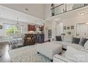 Open-concept living room with hardwood floors, high ceilings, and abundant natural light at 5379 Roberta Meadows Ct, Concord, NC 28027