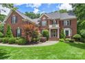 Charming brick home with well-maintained landscaping, black shutters, and a welcoming front entrance at 6006 Casswell Cir, Matthews, NC 28104