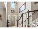 Grand foyer with soaring ceilings, a chandelier, staircase with wood banister, and a large front door at 6006 Casswell Cir, Matthews, NC 28104