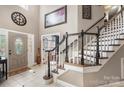 Grand foyer showcasing a staircase, tiled floor, and a decorative glass front door, creating a welcoming entrance at 6006 Casswell Cir, Matthews, NC 28104
