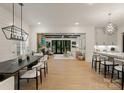 Open-concept living and dining area with hardwood floors and modern finishes, seamlessly connecting to the kitchen at 6242 Creola Rd, Charlotte, NC 28270