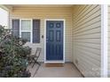 Inviting entryway featuring a stylish blue front door and neutral siding at 6945 Agava Ln, Charlotte, NC 28215