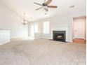 Spacious living room featuring a fireplace, a ceiling fan, and sliding glass doors at 703 Bradberry Ln, Indian Trail, NC 28079
