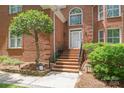 Close up of front entry steps with brick facade and manicured landscaping at 7301 Leharne Dr, Charlotte, NC 28270