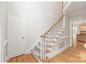 Open foyer with staircase, hardwood floors, and door to side entry at 7301 Leharne Dr, Charlotte, NC 28270