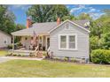 Charming single-story home with a cozy front porch, swing and well-manicured landscaping at 810 Maplewood Ave, Kannapolis, NC 28081
