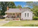 Charming single-story home with a cozy front porch, swing and well-manicured landscaping at 810 Maplewood Ave, Kannapolis, NC 28081