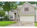 Two-story home with light brown siding, red shutters, attached garage, and covered front entrance with white pillars at 8618 Sam Dee Rd, Charlotte, NC 28215