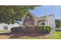 Lovely single-story home with stone and siding exterior and charming front porch, enhanced by neatly trimmed landscaping at 9030 Gander Dr, Charlotte, NC 28277