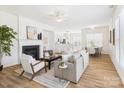 Open-concept living area with a fireplace, neutral decor, hardwood floors and lots of natural light at 9030 Gander Dr, Charlotte, NC 28277