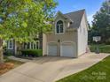 Two-story home with two-car garage, basketball hoop, and well-maintained landscaping at 9038 Sandpiper Dr, Charlotte, NC 28277