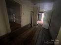Hallway with views of additional rooms, showing signs of needed repair at 0 Woodleaf Rd, Salisbury, NC 28147