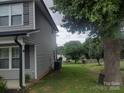 Exterior side view with green lawn, mature tree, and vinyl siding on home at 1017 W C St, Kannapolis, NC 28081