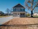 Well-maintained home with a long driveway and a spacious front yard, providing ample parking and curb appeal at 1017 W C St, Kannapolis, NC 28081