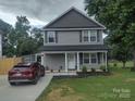 Charming two-story home with a covered front porch and well-maintained landscaping at 1017 W C St, Kannapolis, NC 28081