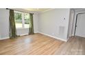Bright bedroom featuring wood flooring, a window and base molding at 1020 N Ransom St, Gastonia, NC 28052