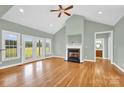 Bright living room featuring a fireplace, hardwood floors, and access to the backyard at 116 Postell Dr, Statesville, NC 28625