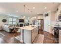 Open concept kitchen with a large center island, stainless appliances, and hardwood floors at 125 Rosebay Dr, Mooresville, NC 28117