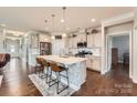 Stylish kitchen featuring white cabinets, stainless steel appliances, and an island with bar seating at 125 Rosebay Dr, Mooresville, NC 28117