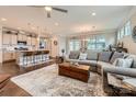 Spacious open-concept living room with hardwood floors, a ceiling fan, and a large comfortable sofa at 125 Rosebay Dr, Mooresville, NC 28117