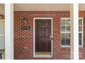 A close-up of the brick front entrance showing the house number and a dark wooden door at 12516 Hennigan Place Ln, Charlotte, NC 28214