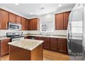 Modern kitchen with granite counters, stainless steel appliances, and ample cabinet space at 15209 Loire Valley St, Charlotte, NC 28277