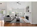 Bright living room with hardwood floors, fireplace, and large windows at 15209 Loire Valley St, Charlotte, NC 28277