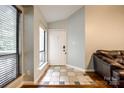 Bright entryway featuring a large window, tile flooring, and a white front door at 1606 Sharon W Rd # 40, Charlotte, NC 28210