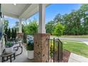 Inviting front porch adorned with potted plants, chairs, and brick columns, providing a cozy outdoor space at 17231 Rider Wood Ln, Charlotte, NC 28278