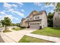Beautiful view of the home's exterior showing the driveway, landscaping, and well-maintained lawn at 1825 Evergreen Dr, Charlotte, NC 28208
