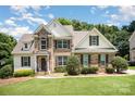Charming brick and siding home with a well-manicured lawn and a picturesque blue sky. A beautiful two-story Gathering home at 1846 Sam Smith Rd, Fort Mill, SC 29708