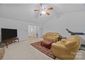 Spacious living room with a ceiling fan, neutral carpet, and ample natural light at 212 Foxfield Ln, Matthews, NC 28105