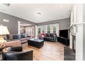 Inviting living room with a fireplace, comfortable seating, hardwood floors, and neutral color at 2240 Arbor Vista Dr, Charlotte, NC 28262