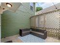 Inviting back patio featuring stylish wicker furniture, decorative string lights, and a privacy lattice wall at 2619 Merion Hills Ct, Charlotte, NC 28269