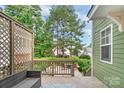Relaxing backyard patio with seating, string lights, and a view of lush greenery and mature trees at 2619 Merion Hills Ct, Charlotte, NC 28269