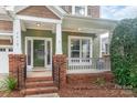 Charming front porch with brick columns, white railings, and a well-maintained landscaped entrance at 2619 Merion Hills Ct, Charlotte, NC 28269