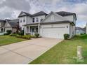 Two-story home featuring an attached two-car garage and well-maintained landscaping at 3009 Palm Dr, Fort Mill, SC 29715