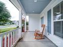 Inviting front porch with rocking chairs and blue shutters, perfect for relaxing at 3009 Palm Dr, Fort Mill, SC 29715
