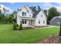 Attractive two-story home with a covered porch, green lawn, and beautifully landscaped flower beds at 3222 Player Ct, Salisbury, NC 28144