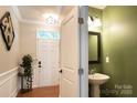 Bright entryway with a decorative wainscoting and a conveniently located half bath at 3537 Hornets Nest Way # 206, Charlotte, NC 28208