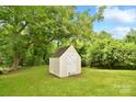 A wooden shed in a large yard surrounded by beautiful trees at 379 Sharpe St, Mooresville, NC 28115