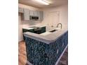 This kitchen offers modern appliances, white subway tile and a patterned kitchen peninsula at 379 Sharpe St, Mooresville, NC 28115