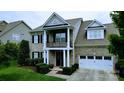 Attractive brick home with white trim, black shutters, a balcony, and an attached two-car garage at 408 Presidio Dr, Rock Hill, SC 29732