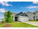 Nice front exterior view featuring landscaped yard and two-car garage at 410 Apex Cir, Shelby, NC 28152