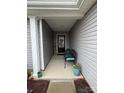 Welcoming covered porch featuring a bench, decorative plants, and stylish accents at 410 Apex Cir, Shelby, NC 28152